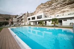 a large blue swimming pool in front of a building at Hotel Spa Elia in Alcalá del Júcar