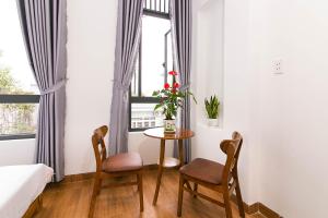 una stanza con un tavolo e due sedie e una finestra di SPOT ON 806 Net Viet Homestay a Da Nang