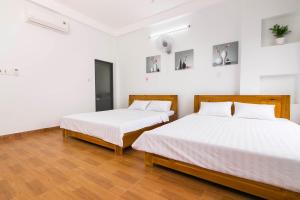 Giường trong phòng chung tại SPOT ON 806 Net Viet Homestay