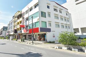 a white building on the side of a street at Hotel O Mini Indah in Kuala Terengganu