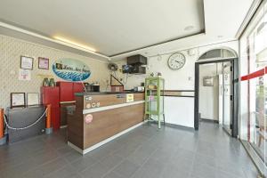 a kitchen with a counter and a clock on the wall at Hotel O Mini Indah in Kuala Terengganu