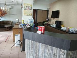 a kitchen with a counter in a room at Hotel O Oriental Hotel in Sarikei