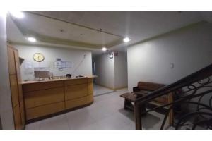een kamer met een aanrecht en een klok aan de muur bij OYO 1066 Dorotello Apartelle in Manilla