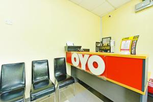 an office with chairs and a desk with an ovo sign at Hotel O Bamboo Inn in Batu Ferringhi
