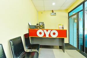 an office with an ovo sign on a desk at Hotel O Bamboo Inn in Batu Ferringhi