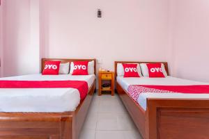 Postel nebo postele na pokoji v ubytování OYO 962 Tulip Motel