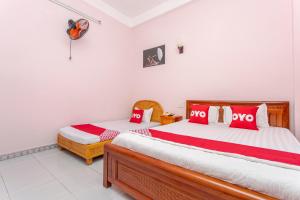 Postel nebo postele na pokoji v ubytování OYO 962 Tulip Motel