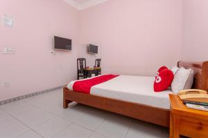 Postel nebo postele na pokoji v ubytování OYO 962 Tulip Motel