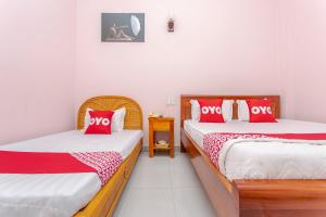 Postel nebo postele na pokoji v ubytování OYO 962 Tulip Motel