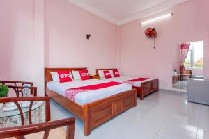 Postel nebo postele na pokoji v ubytování OYO 962 Tulip Motel