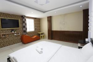 a room with two beds and a flat screen tv at Avatar Hotel in Ho Chi Minh City