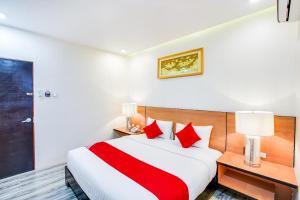 a bedroom with a large bed with red pillows at OYO 489 Casa Mia Hotel Suites in General Santos +53 photos