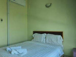a bed with two towels sitting on top of it at Hotel O Good View Inn in Sri Aman