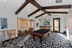 a pool table in a room with a ping pong ball at Spanish Walk Villa - PD condo near acrisure in Palm Desert