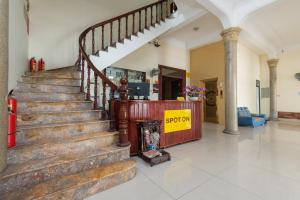 a lobby with a staircase with a sign that says support at Chikoo Homestay spot-on in Hanoi