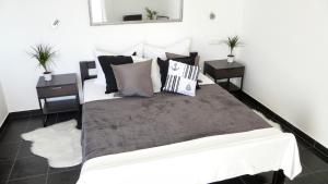 a bedroom with a large bed with two night stands at Apartments Palatium in Kaštela