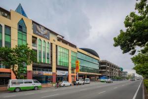 a street with cars parked on the side of a building at Hotel O Storytel in Kota Kinabalu
