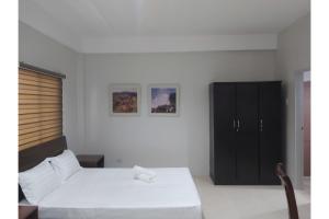 Postel nebo postele na pokoji v ubytování Nest Suites