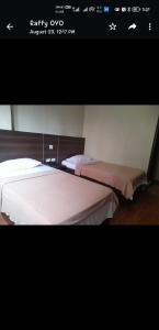 Postel nebo postele na pokoji v ubytování OYO 1011 First Hotel