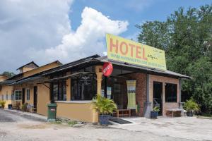 a hotel with a sign on top of it at Hotel O Kay Inn Kerteh in Kertih