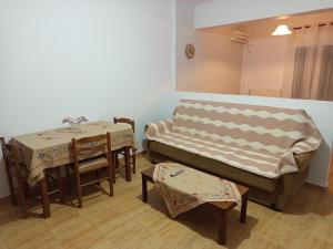 a room with a bed and a table and chairs at Dora and Sandy apartments 2 in Oikonomiánika