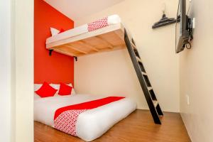 a bedroom with a bunk bed and a ladder at OYO 778 Bmw 2 Hotel in Muar