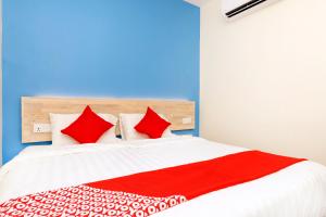a bedroom with a bed with red pillows at OYO 778 Bmw 2 Hotel in Muar