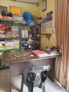 a desk with a chair in a room at Hotel O Bayu Chalet in Kota Bharu
