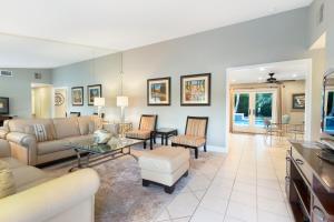 a living room with a couch and a table at Vintage Paseo Getaway in Palm Desert