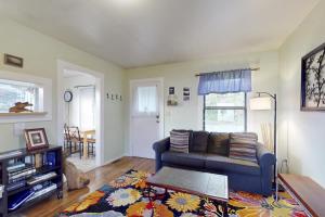 a living room with a couch and a table at Greenwood Beach Cottage in Elk