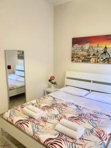 a bedroom with a large bed with towels on it at Easy Suite Roma San Pietro in Rome
