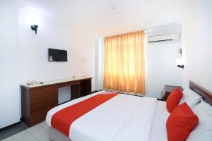 Postel nebo postele na pokoji v ubytování Super OYO 1018 Telang Usan Hotel Miri
