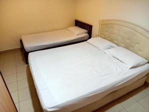 Postel nebo postele na pokoji v ubytování OYO 90842 Hotel Prai Jaya