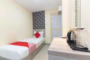 Postel nebo postele na pokoji v ubytování OYO 552 Hotel Kl Centre Point