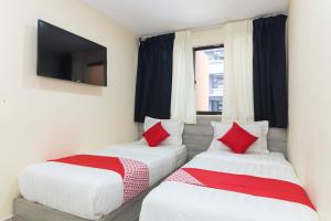 Postel nebo postele na pokoji v ubytování OYO 552 Hotel Kl Centre Point