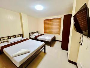 Postel nebo postele na pokoji v ubytování OYO 1045 Rayjan Apartelle