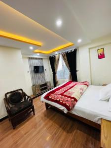 a bedroom with a large bed and a tv at Paradise View Hotel & Restaurant in Khaira Gali