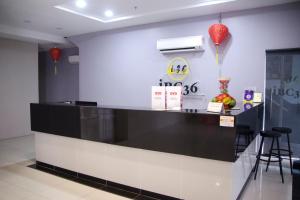 a black and white counter in a restaurant with red balloons at Hotel O iBC36 Business Stay in Kuching +26 photos