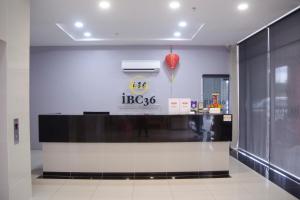 a restaurant with a black and white counter in a building at Hotel O iBC36 Business Stay in Kuching