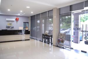 a lobby with a table in the middle of a building at Hotel O iBC36 Business Stay in Kuching