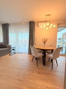 a dining room with a table and chairs at Apartament Uzdrowiskowy HYGGE GJ I in Busko-Zdrój