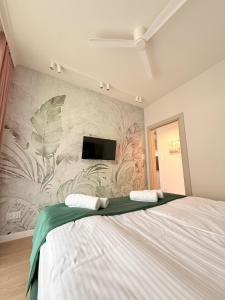 a bedroom with a large bed with a wall mural at Apartament Uzdrowiskowy HYGGE GJ I in Busko-Zdrój +11 photos