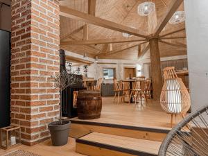 an open living room with a brick and wood ceiling at Camping Ursulet Durau in Ceahlău