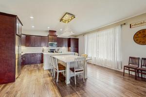 a kitchen with a white table and chairs and a clock at Tiffany Lake House in Manson
