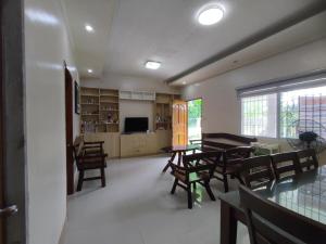 a living room with a dining room table and chairs at Hideaway Camiguin Homestay in Mambajao