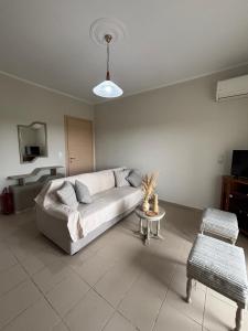 a living room with a couch and a table at Apartment 14 Lemnos in Kalliópi