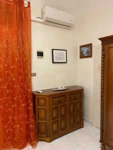 a room with a wooden cabinet and a curtain at La Casetta da Silvia in Bisceglie +10 photos