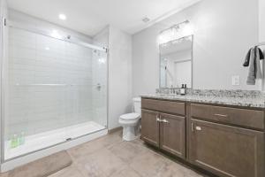 a bathroom with a tub and a sink and a toilet at Luxe Condo in Downtown Cleveland l 2 TV's l Parking in Cleveland