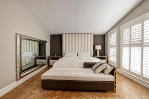 a bedroom with a large bed and a large mirror at Joyful Mansion with Charm Indoor in Mississauga