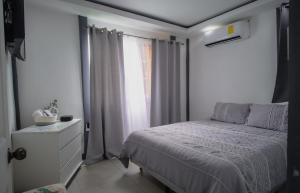 a white bedroom with a bed and a window at Deluxe beach house in Westfalia +20 photos